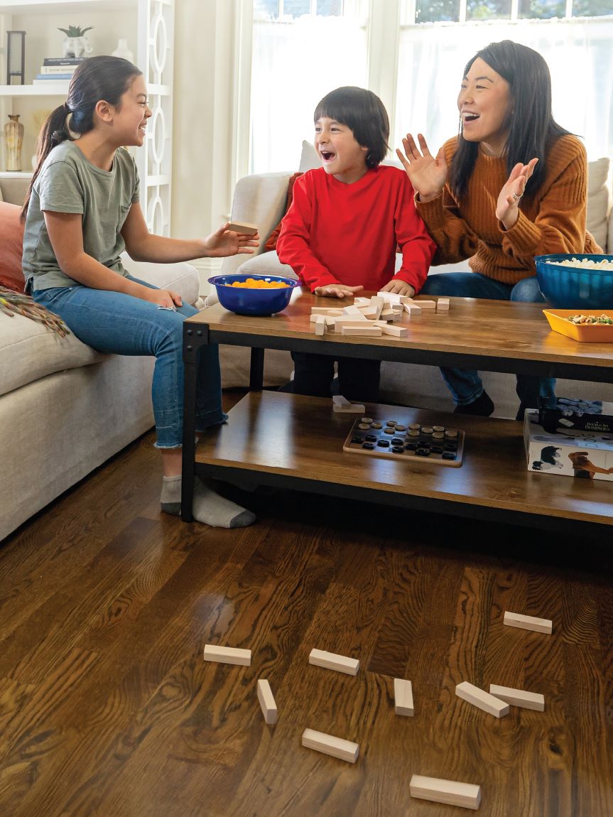 Mom and daughter playing with tablet on hard surface floor